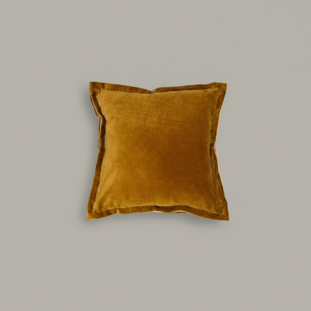 Mustard yellow pillow on a gray background