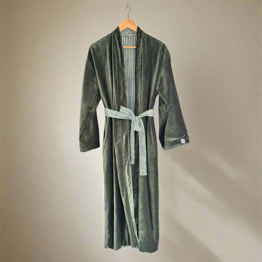Green cotton velvet  reversible robe with a striped tie on a hanger against a white background